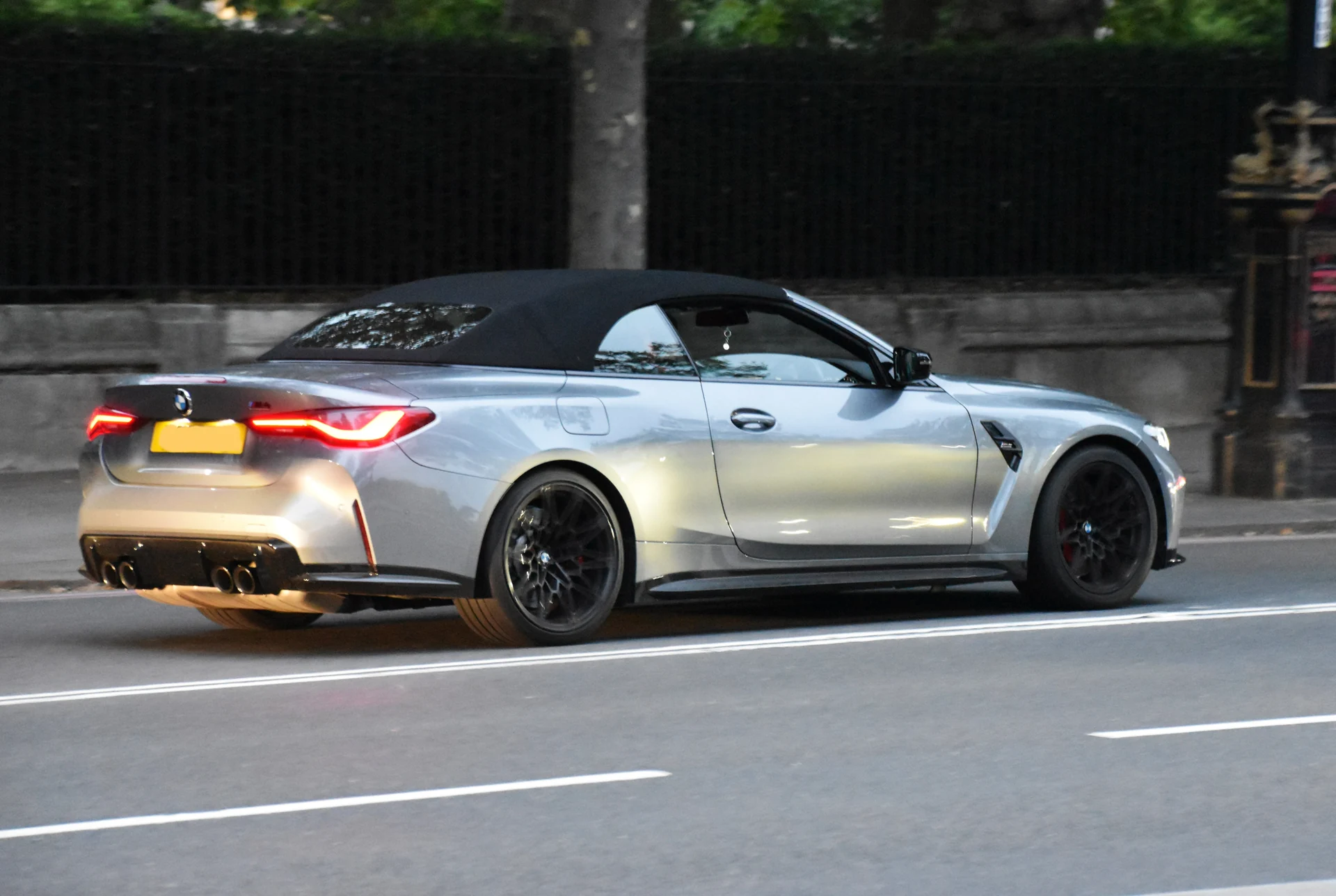 Silver BMW M4 Competition convertible on a London road